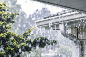 Drenching downpour rain storm water is overflowing off gutters